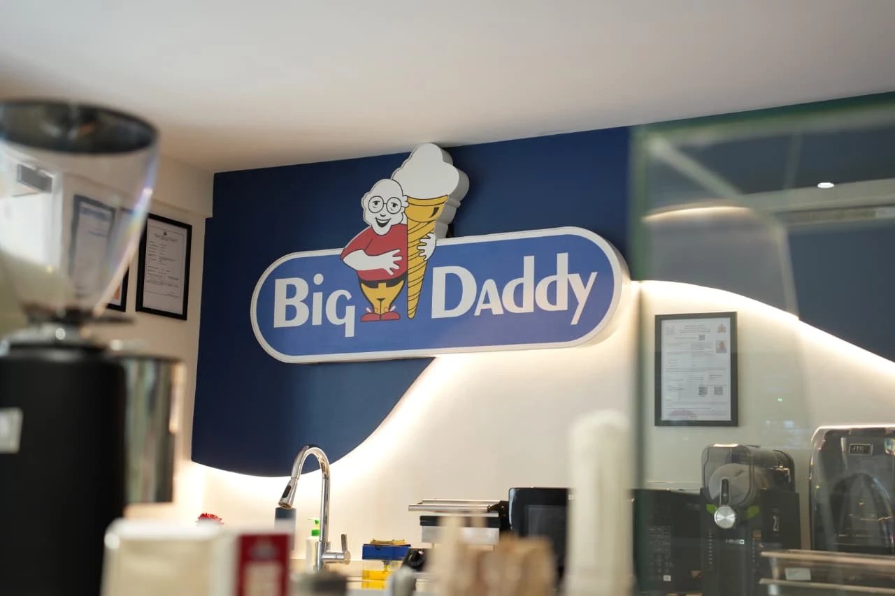 Big Daddy logo sign on the blue wall at Big Daddy Creamery and Cafe, Banaswadi